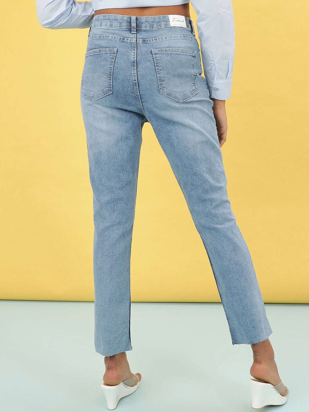 Shop Women Light Wash Straight Fit Denim Jeans Online.